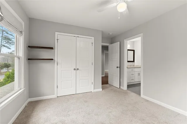 an empty room with windows and closet