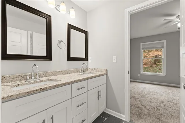 a bathroom with double sink and a mirror