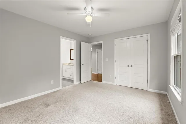 an empty room with fan and entrance