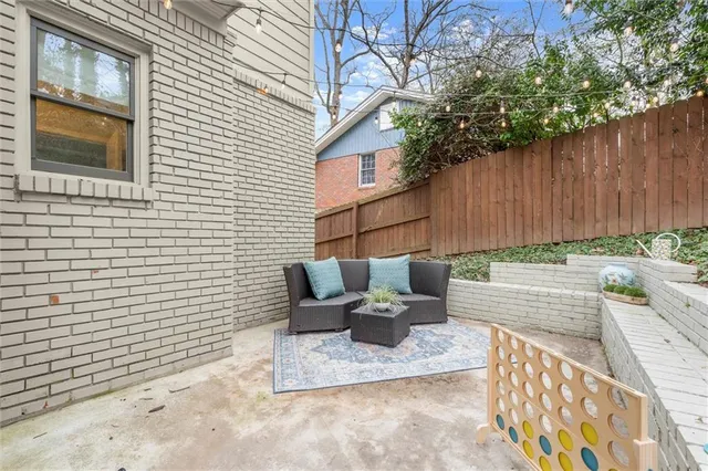 a view of a backyard with sitting area
