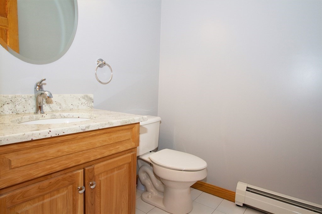 22 Edgemere Road North Reading, MA 01864 - Photo 14 of 42 a bathroom with a toilet sink and mirror
