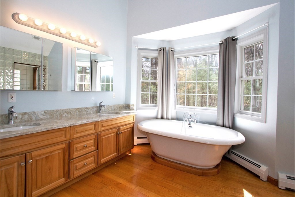 22 Edgemere Road North Reading, MA 01864 - Photo 16 of 42 a spacious bathroom with a tub double sink and mirror