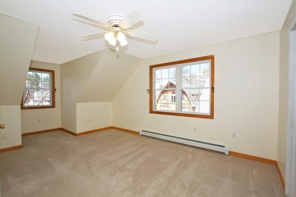 22 Edgemere Road North Reading, MA 01864 - Photo 23 of 42 an empty room with windows and fan