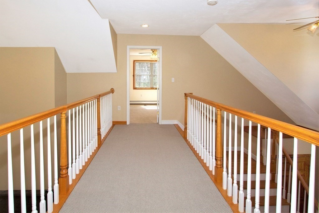 22 Edgemere Road North Reading, MA 01864 - Photo 25 of 42 a view of a hallway with wooden floor and a bathroom