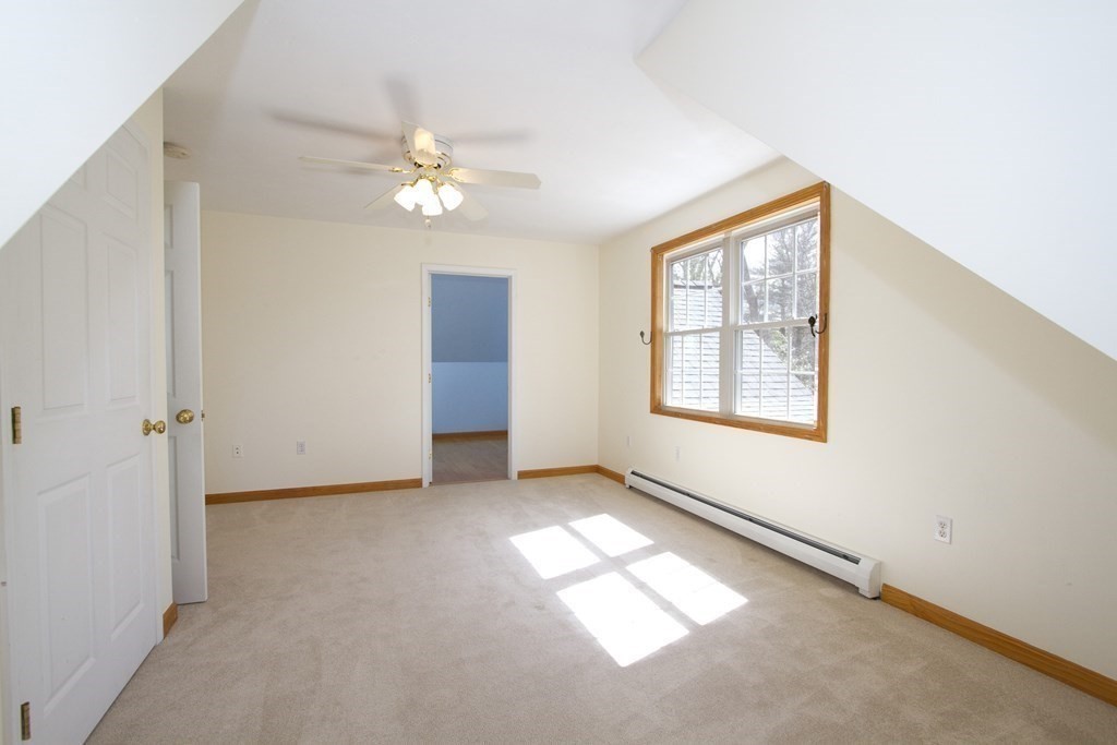 22 Edgemere Road North Reading, MA 01864 - Photo 26 of 42 an empty room with windows and fan