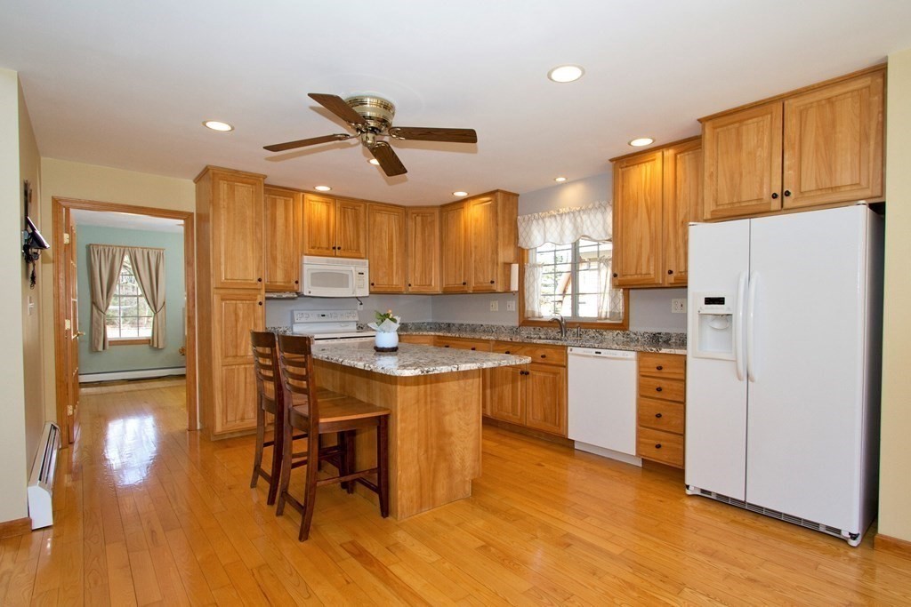 22 Edgemere Road North Reading, MA 01864 - Photo 3 of 42 a kitchen with a refrigerator a white table and chairs