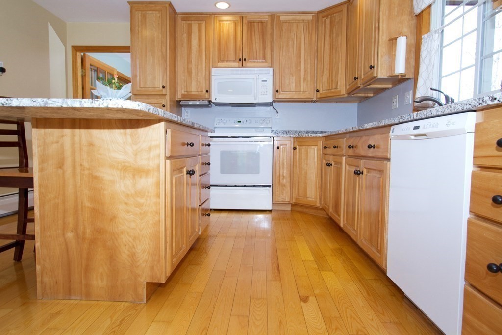 22 Edgemere Road North Reading, MA 01864 - Photo 5 of 42 a kitchen with stainless steel appliances a refrigerator and a stove