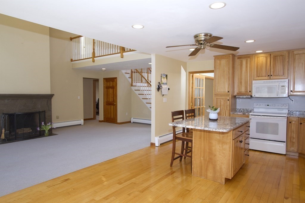 22 Edgemere Road North Reading, MA 01864 - Photo 6 of 42 a kitchen with stainless steel appliances granite countertop a stove and a refrigerator