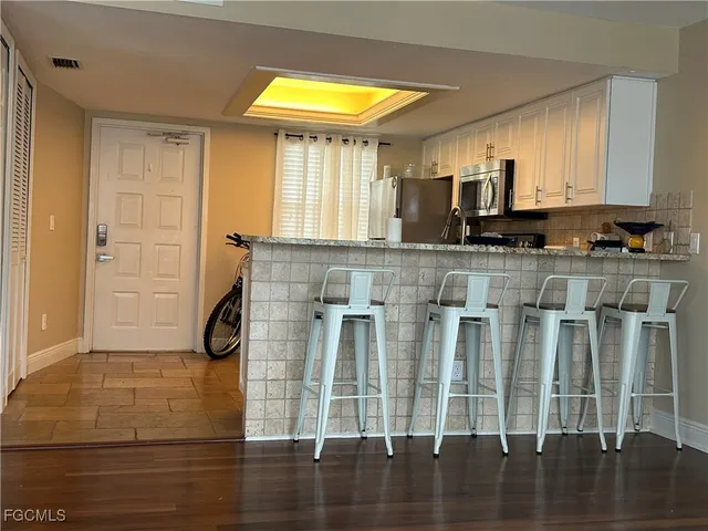 a view of kitchen with wooden floor and a window