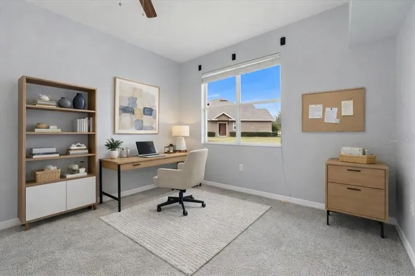 a view of an empty room and a ceiling fan