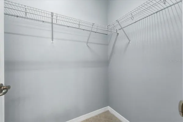 a bathroom with a granite countertop toilet sink and mirror