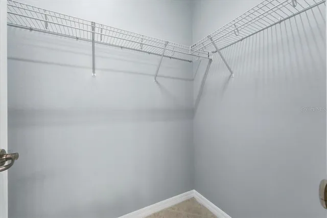 a bathroom with a granite countertop toilet sink and mirror