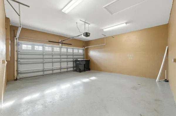 a view of a patio with a table and chairs under an umbrella