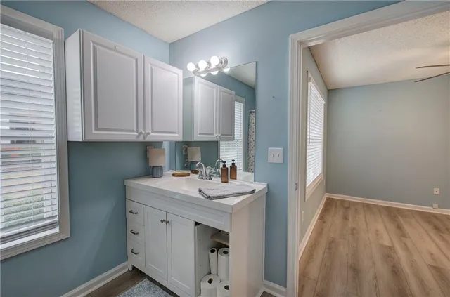 a kitchen with a sink cabinets and a window