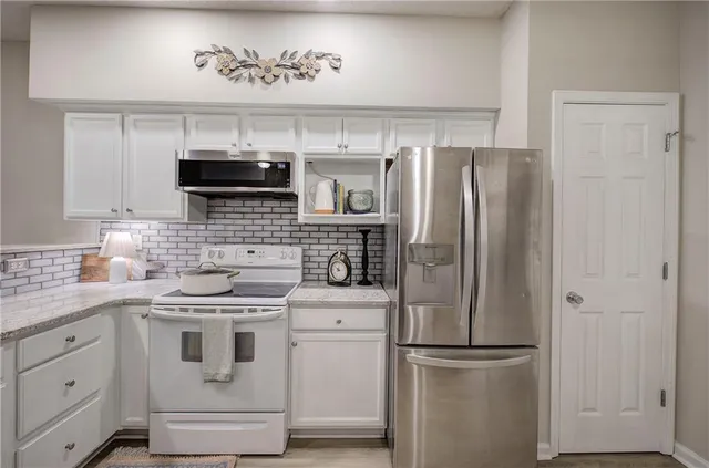 a kitchen with a refrigerator stove and sink