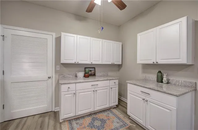 a kitchen with white cabinets stainless steel appliances and sink