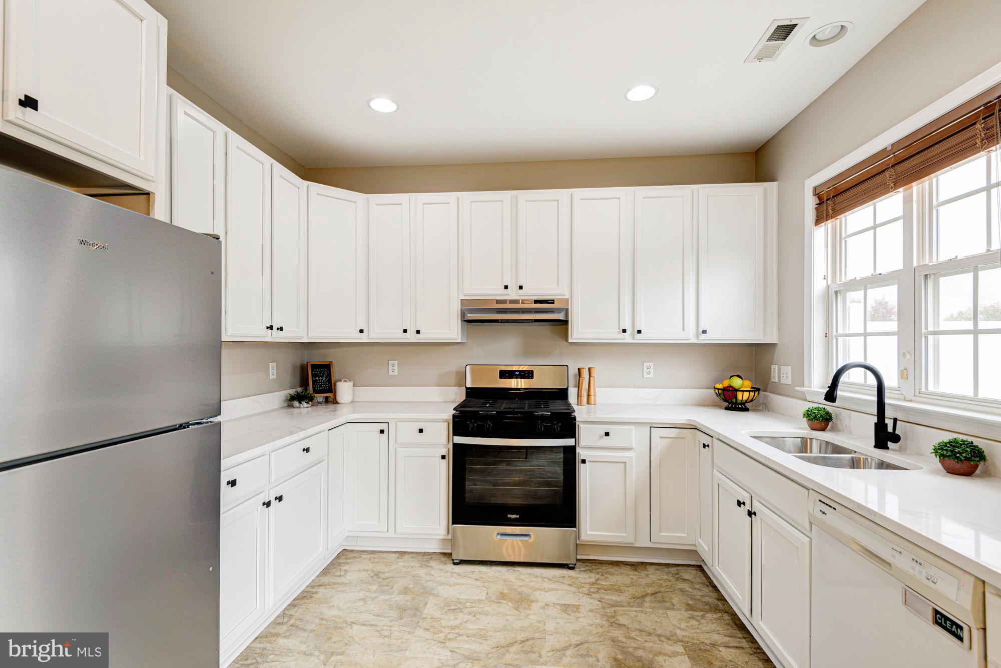 164 Springfield Circle Middletown, DE 19709 - Photo 15 of 49 a kitchen with white cabinets and appliances