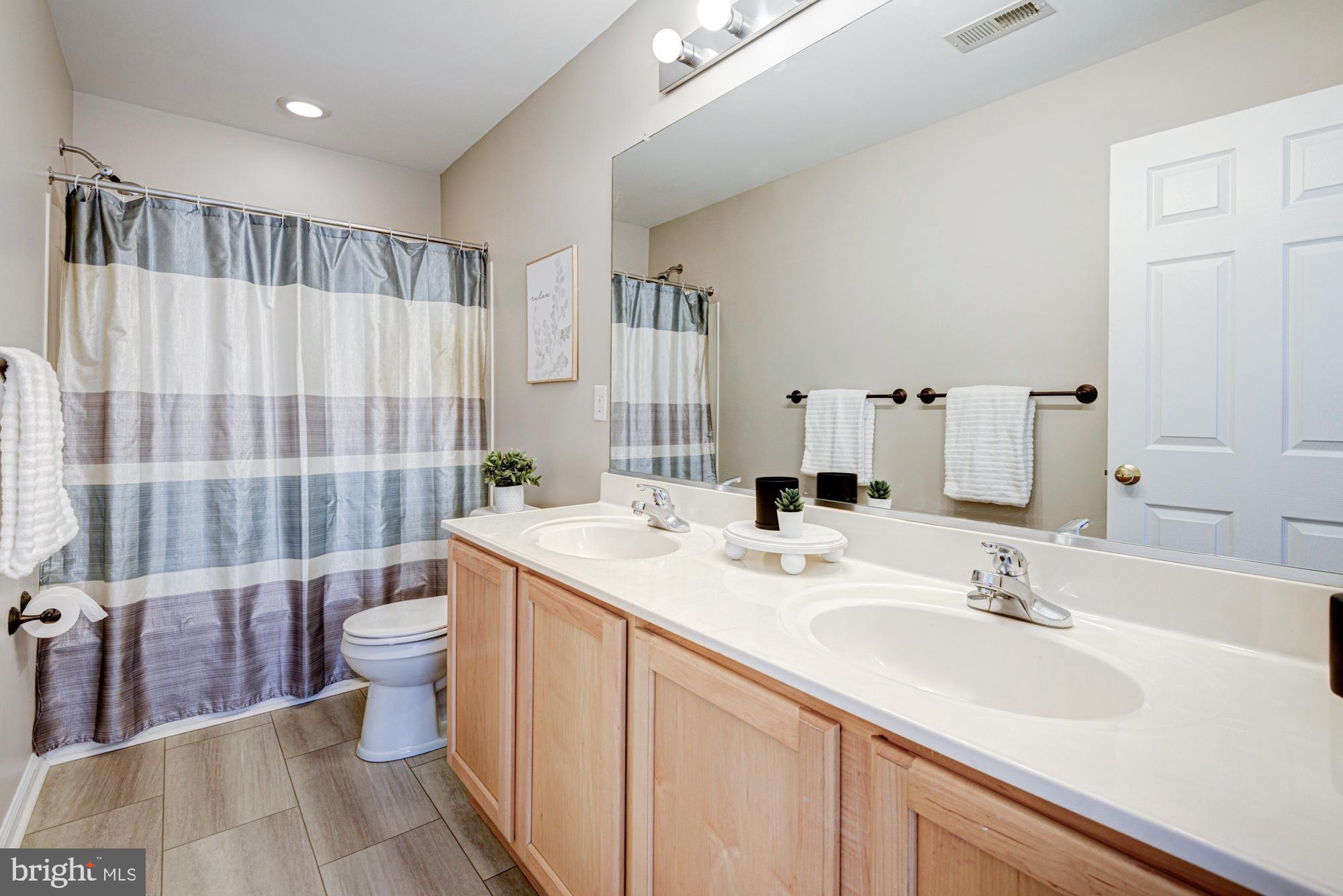 164 Springfield Circle Middletown, DE 19709 - Photo 25 of 49 a bathroom with a double vanity sink toilet and shower