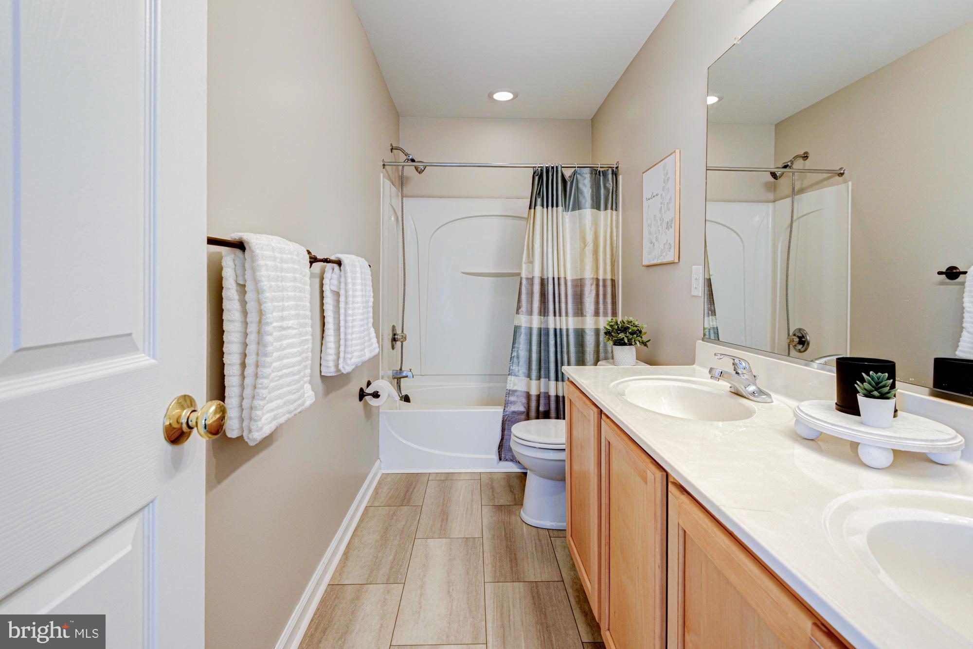 164 Springfield Circle Middletown, DE 19709 - Photo 26 of 49 a bathroom with a double vanity sink a mirror and shower