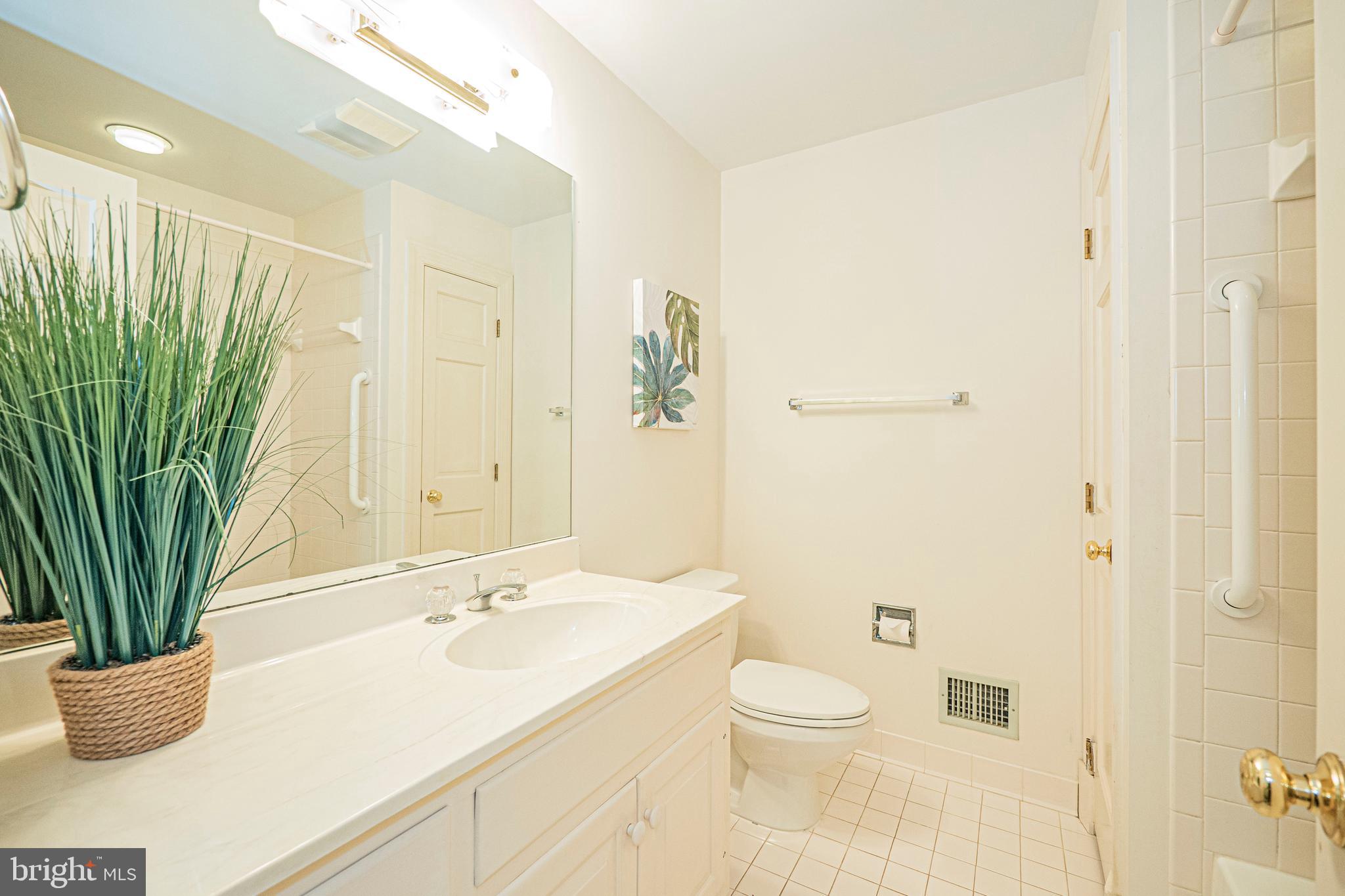 10100 Watkins Road Gaithersburg, MD 20882 - Photo 81 of 113 a bathroom with a granite countertop sink a toilet and a shower