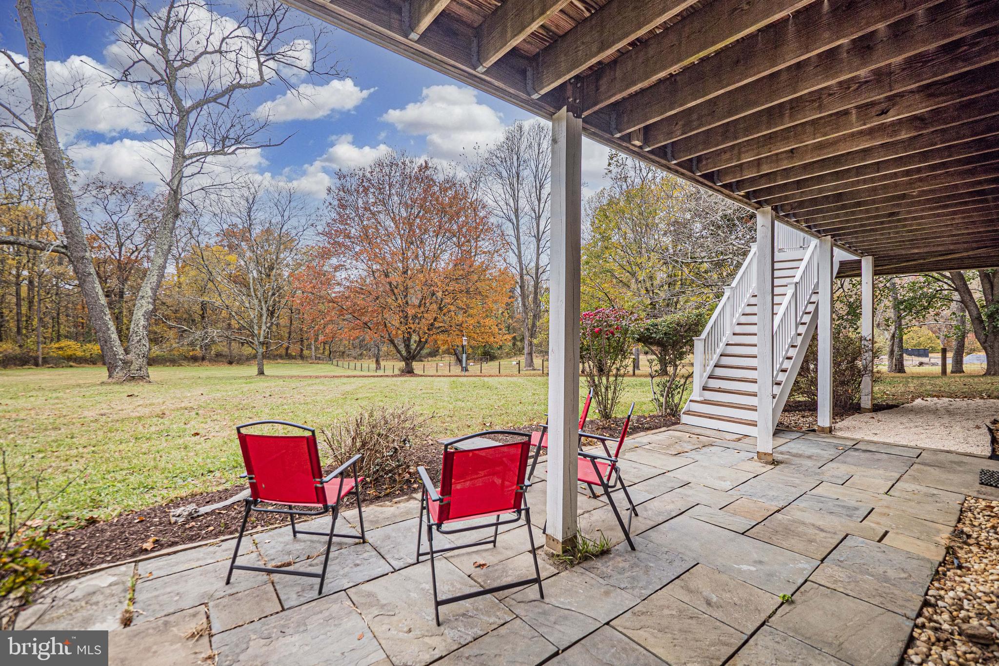 10100 Watkins Road Gaithersburg, MD 20882 - Photo 88 of 113 a view of a swimming pool with red chairs in front of it