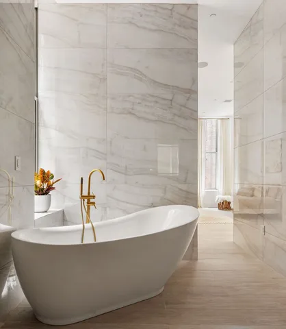 a white bath tub sitting in a bathroom