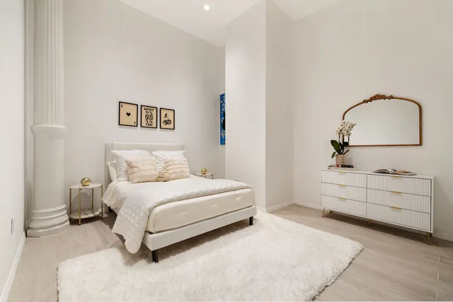 a bedroom with a bed and a dresser