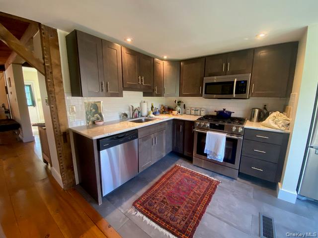 1640-1642 Bulls Head Road Clinton Corners, NY 12514 - Photo 9 of 19 a kitchen with stainless steel appliances granite countertop a sink stove and refrigerator