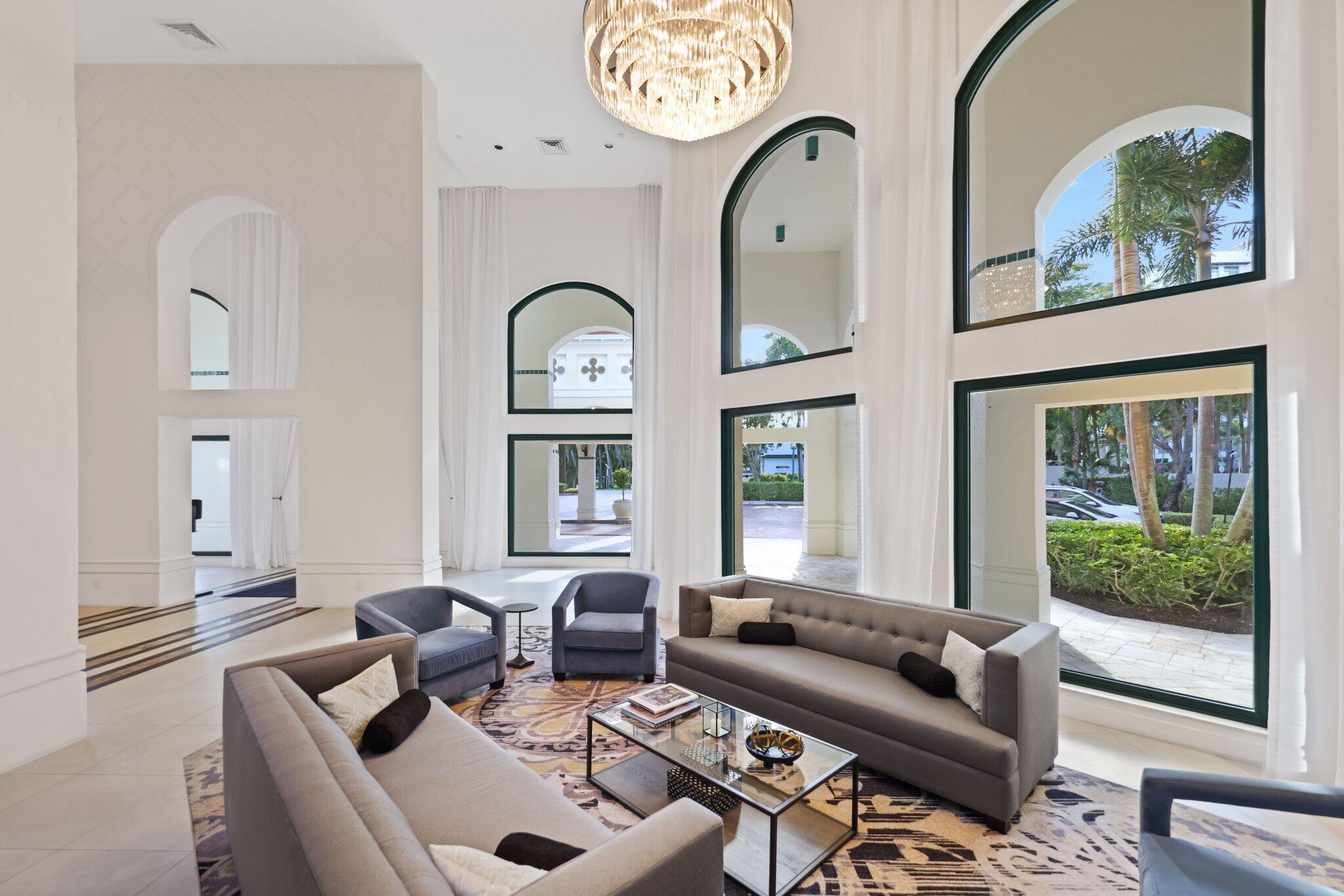 100 Southeast 5th Avenue, Unit 106 Boca Raton, FL 33432 - Photo 59 of 81 a living room with furniture a fireplace and a large window