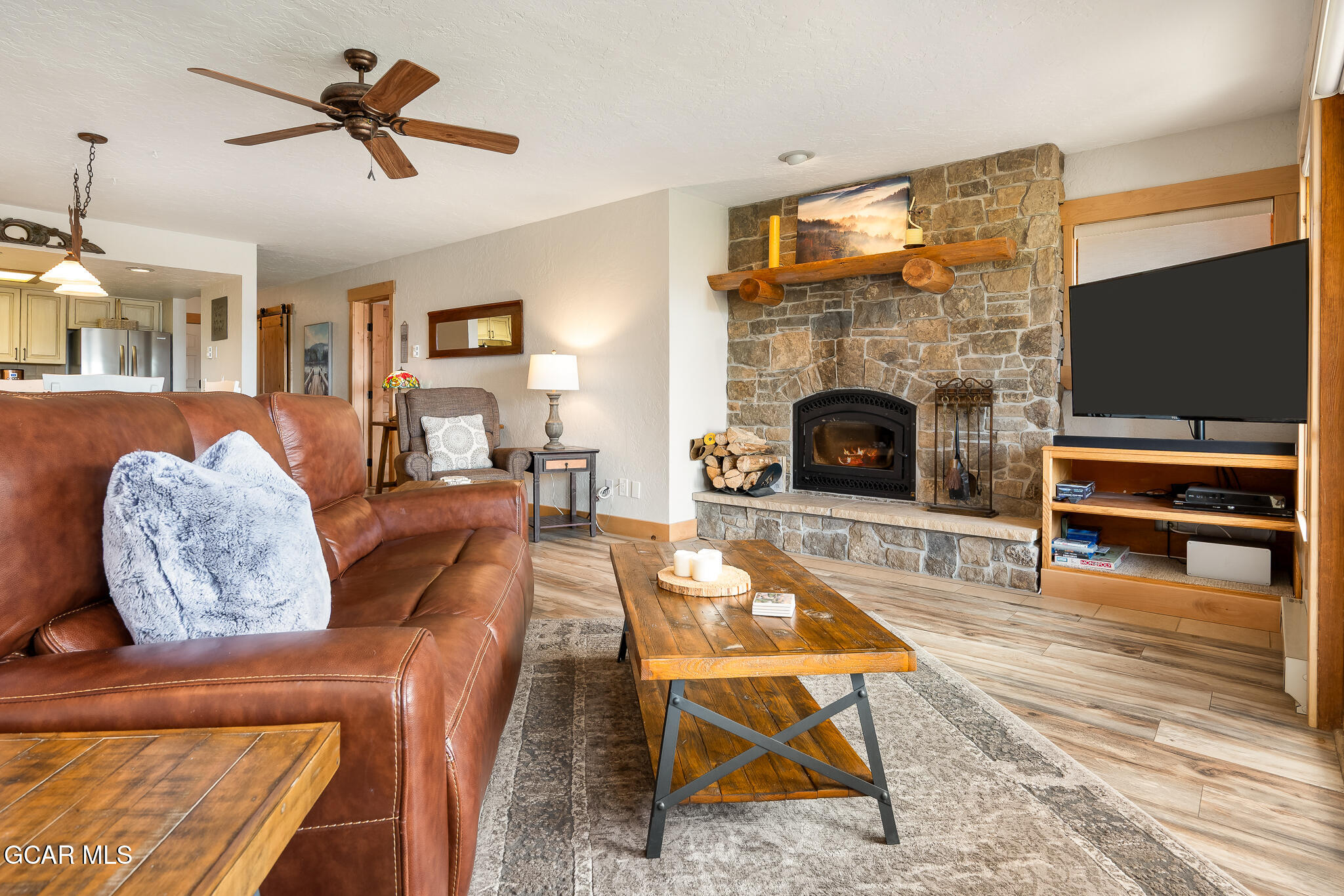 605 Lake Front Road, Unit W8 Grand Lake, CO 80447 - Photo 9 of 28 a living room with furniture a flat screen tv and a fireplace