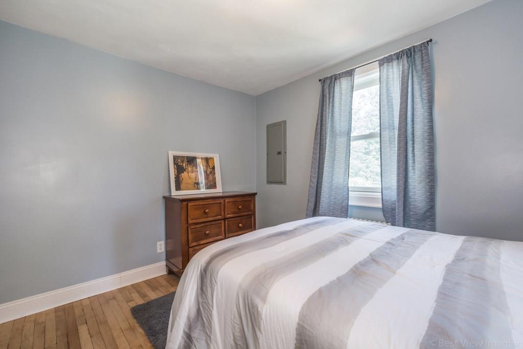 148 Sterling Road Lancaster, MA 01523 - Photo 20 of 39 a bedroom with a bed and wooden floor