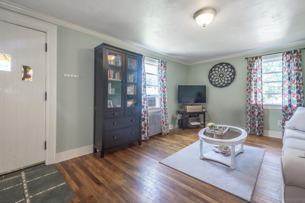 148 Sterling Road Lancaster, MA 01523 - Photo 3 of 39 a living room with furniture a window and wooden floor