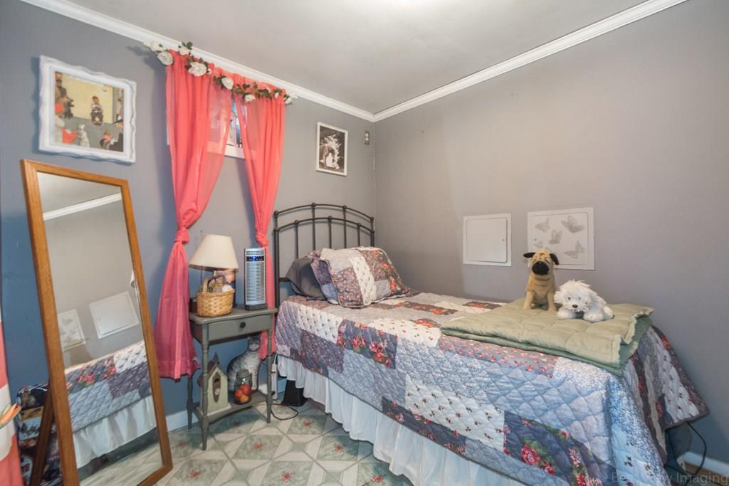 148 Sterling Road Lancaster, MA 01523 - Photo 34 of 39 a bedroom with a bed a couch and dresser