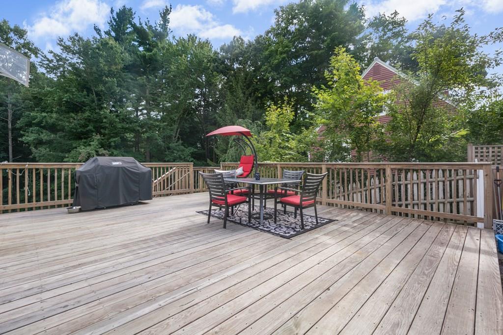 148 Sterling Road Lancaster, MA 01523 - Photo 36 of 39 a view of a roof deck with table and chairs and wooden floor