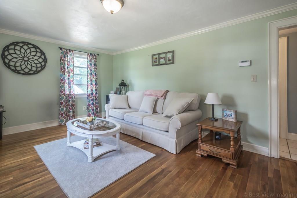 148 Sterling Road Lancaster, MA 01523 - Photo 4 of 39 a living room with furniture and a wooden floor