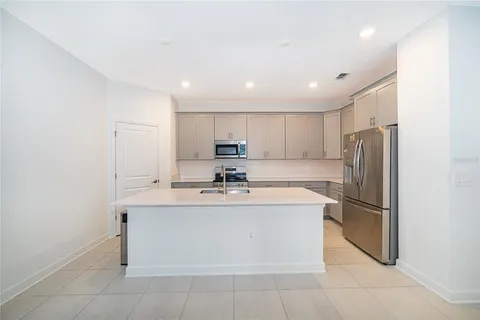 a living room with kitchen island furniture and a large window