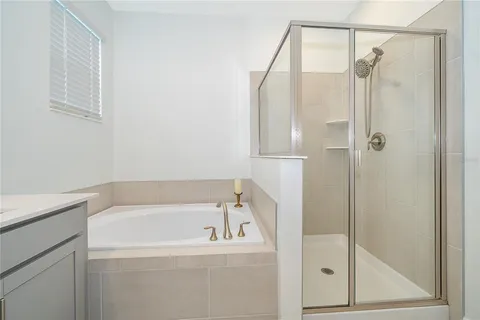 a bedroom with a bed and dresser with mirror