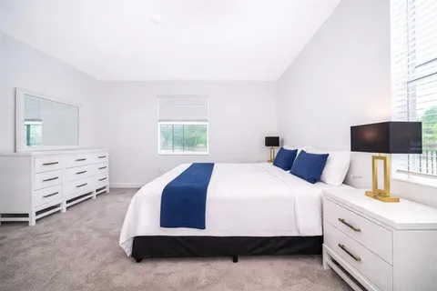 a bedroom with bed and a night stand