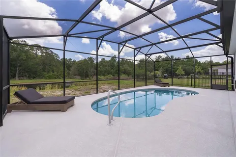 a view of a swimming pool with outdoor seating