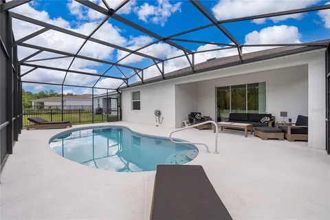 a view of a swimming pool with a patio