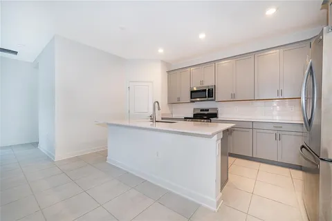 a kitchen with stainless steel appliances a refrigerator sink and cabinets