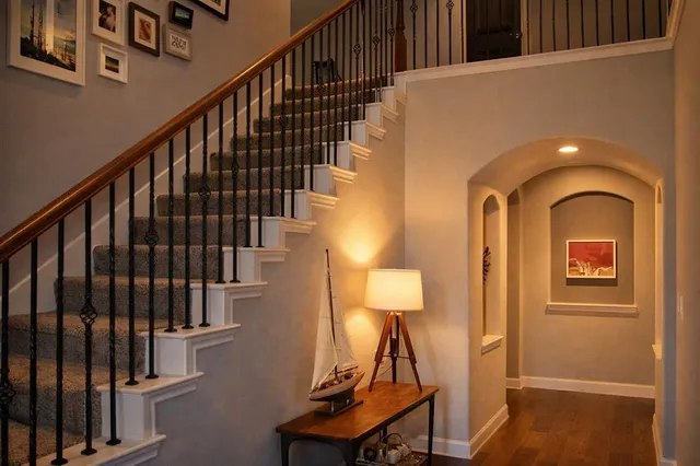 a view of entryway and hall with wooden floor