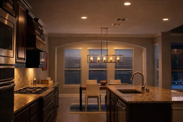 a kitchen with a counter space a stove and a refrigerator
