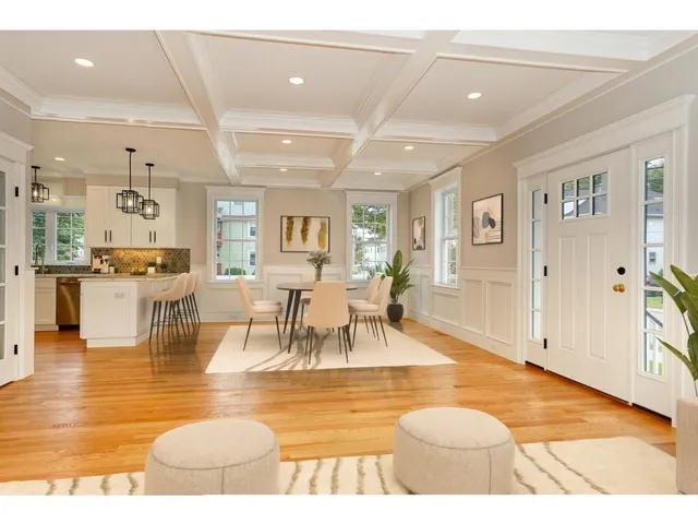 a living room with dining room and kitchen view