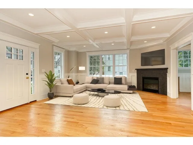 a living room with furniture large window and a fireplace