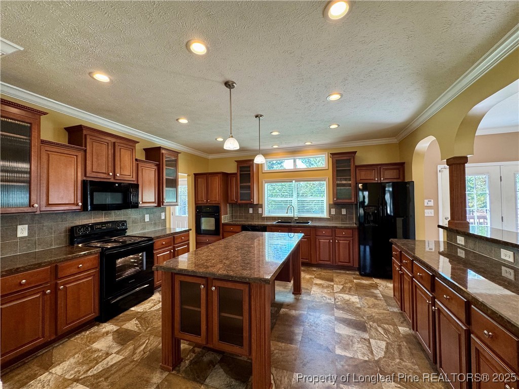 3273 Cameron Hill Road Cameron, NC 28326 - Photo 13 of 36 a kitchen with stainless steel appliances granite countertop a stove top oven a sink a dining table and chairs
