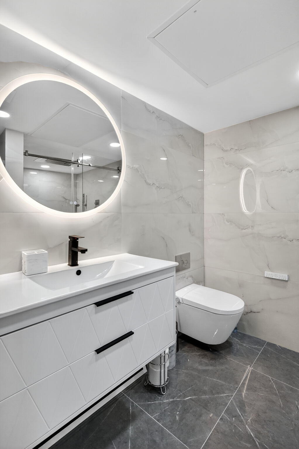 5225 Collins Avenue, Unit 1408 Miami Beach, FL 33140 - Photo 14 of 37 a bathroom with a sink a toilet and a mirror