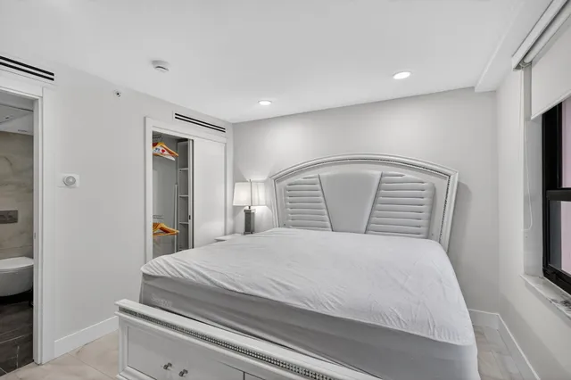 a bedroom with a large bed and a tv