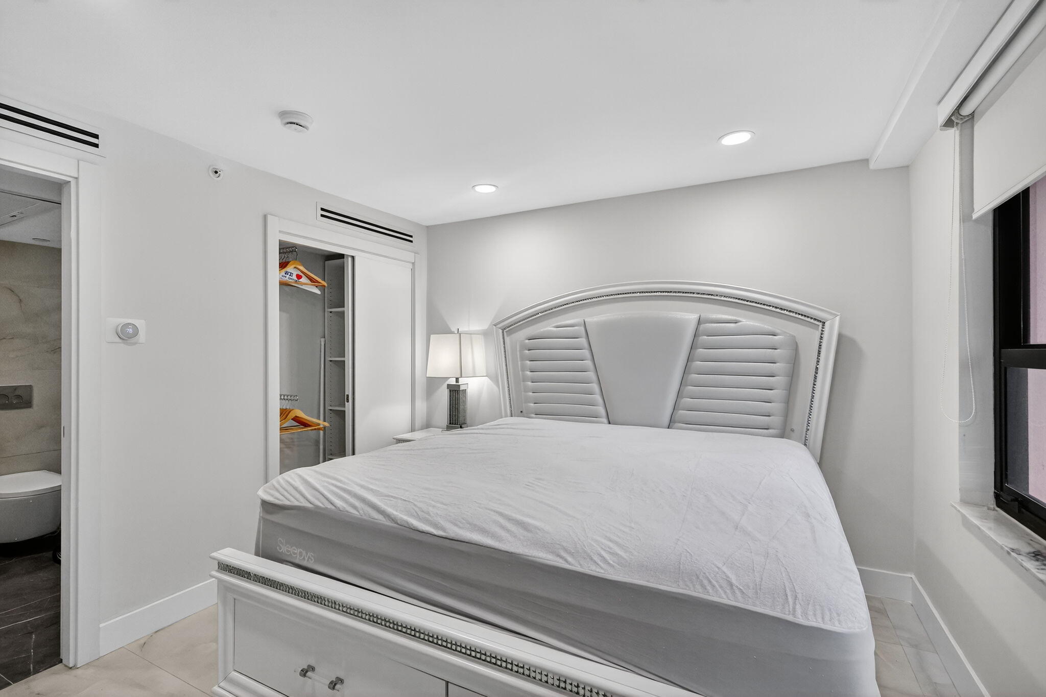 5225 Collins Avenue, Unit 1408 Miami Beach, FL 33140 - Photo 17 of 37 a bedroom with a large bed and a tv