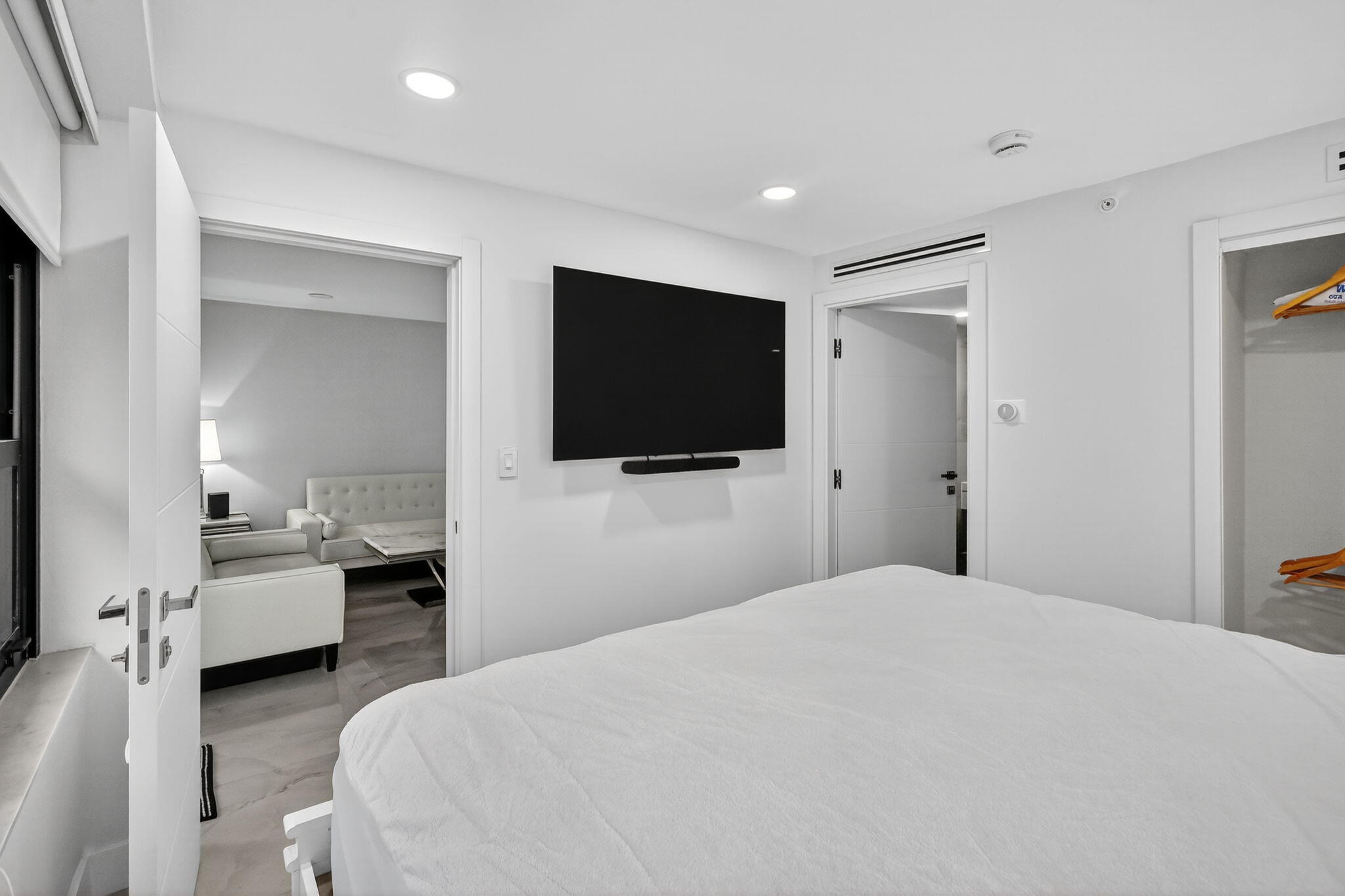 5225 Collins Avenue, Unit 1408 Miami Beach, FL 33140 - Photo 18 of 37 a bedroom with a bed and a flat screen tv